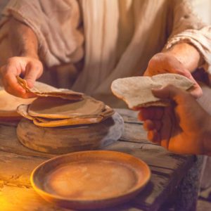 Image of Jesus breaking and sharing bread, depicting Goal #1: Abundant Spiritual Opportunities