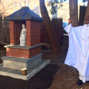Father Chumo blesses the outdoor Mary Shrine