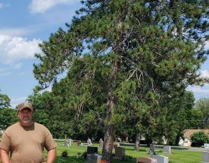 Man stands in a cemetery