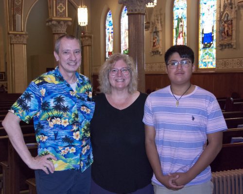 a man, woman and child stand together in a church