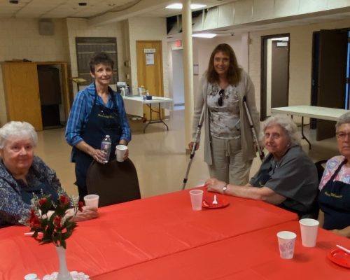 Hospitality team members sit at a table.