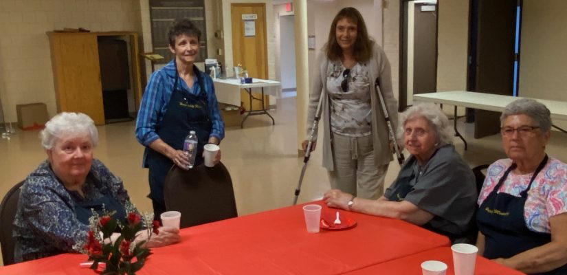 Hospitality team members sit at a table.