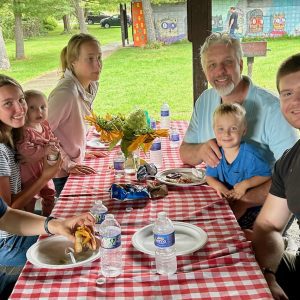 Family sitting at a table at a picnic
