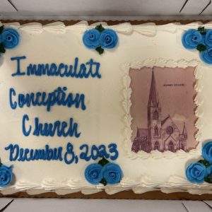 A cake with an image of the Immaculate Conception Church with writing: Immaculate Conception Church December 8, 2023