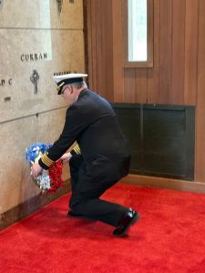 Navy Captain Dan Weed lays wreath during ceremony