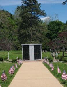 American Flags, placed by VFW Post 961 members, honor the many Veterans buried in Calvary Cemetery on Memorial Day 2026.
