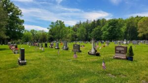 American Flags, placed by VFW Post 961 members, honor the many Veterans buried in Calvary Cemetery on Memorial Day 2026.