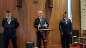 Senior Vice-Commander and Worthy Sir Knight Dan Weed, flanked by members of the Ithaca VFW Post 961 Color Guard speaks during the annual Memorial Day Ceremony in Calvary Cemetery.